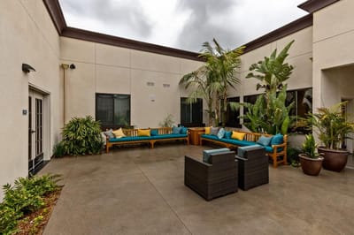 A serene outdoor courtyard with seating and greenery