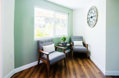 Cozy seating area with plants and a clock