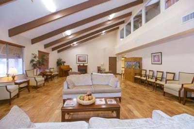 Bright interior common area with seating and piano