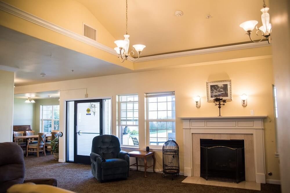 Interior of a cozy common area with seating and fireplace