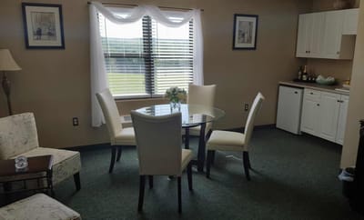 Cozy resident room with dining table and chairs