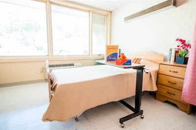 A well-furnished resident room with natural light