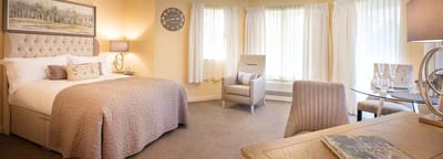 Cozy private resident room with a bed and seating area