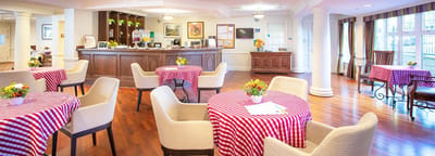 Interior dining area with checkered tablecloths and floral centerpieces