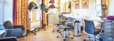 Well-equipped salon area with styling chairs and equipment