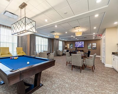 Bright common area with a pool table and seating