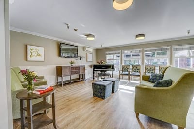 Bright common area with seating and piano