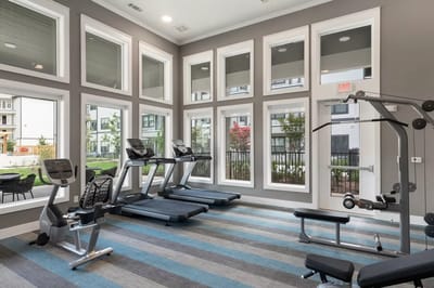 Fitness area with exercise equipment and large windows