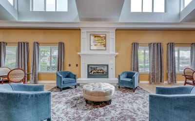 Bright common area with seating and fireplace