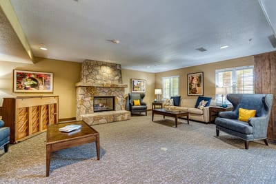 Cozy common area with seating and stone fireplace
