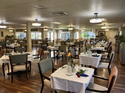 Dining room setup with tables and floral decorations