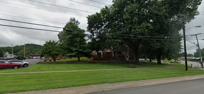 Well-maintained outdoor space with trees and grassy areas