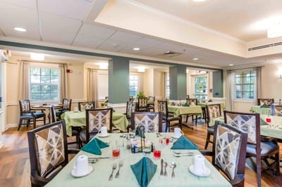 Dining room set for a meal with green tablecloths
