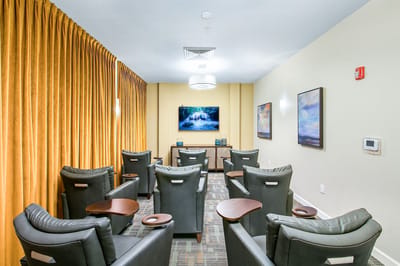 Comfortable theater room with seating and a screen