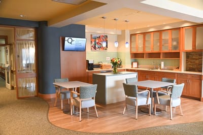 Bright common area with seating and kitchen