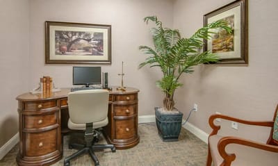 A small office space with a desk and plant