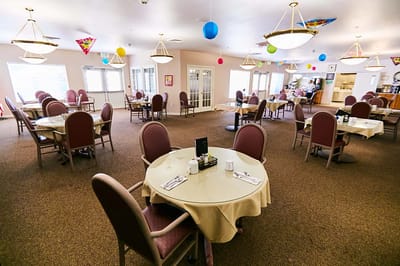 Dine-in area with tables and chairs set up for residents