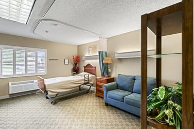 Private resident room with a bed and seating area
