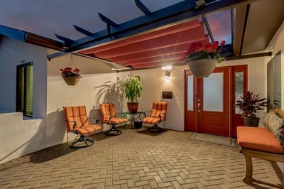 Outdoor seating area with potted plants and vibrant cushions