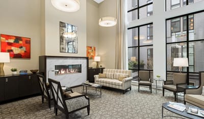 Bright and modern common area with seating and fireplace