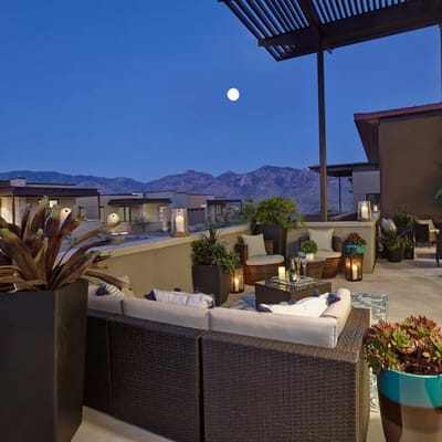 Outdoor seating area with mountain view at dusk