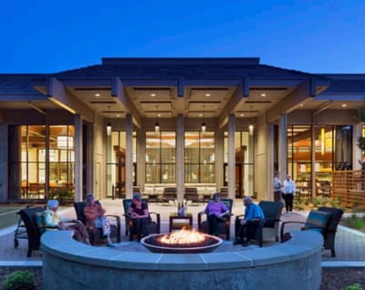 Residents enjoying an outdoor fire pit area at dusk