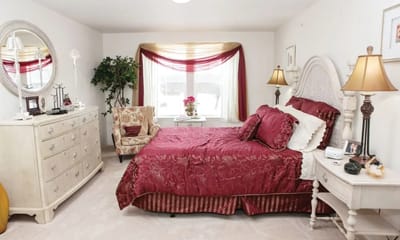 Cozy bedroom setup with rich red decor