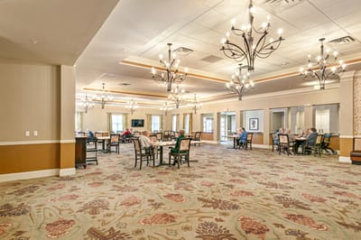 Residents socializing in a common area with decorative lighting