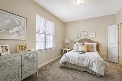 Cozy bedroom in a senior living facility with soft decor