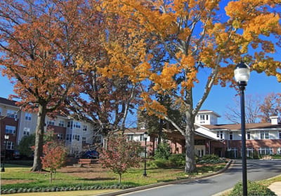 Exterior view of St. George Village with autumn trees