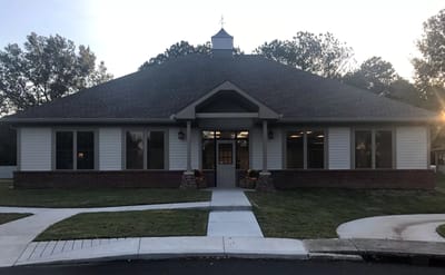 Exterior view of St. Joseph Village building at sunset