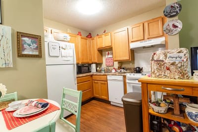 Cozy kitchen area with wooden cabinets and appliances