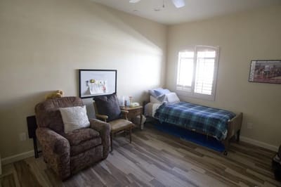 Cozy resident room with a bed and chair
