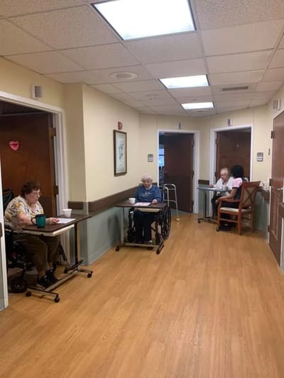Residents engaging in activities in a facility hallway