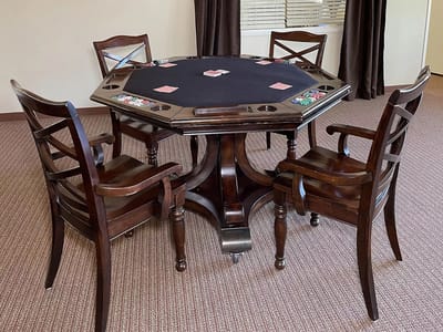 A poker table with chairs in an indoor space