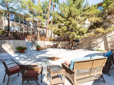 Outdoor space with seating and surrounding trees