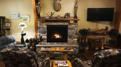 Cozy common area with a stone fireplace and seating
