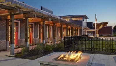Exterior view of the facility with a fire pit
