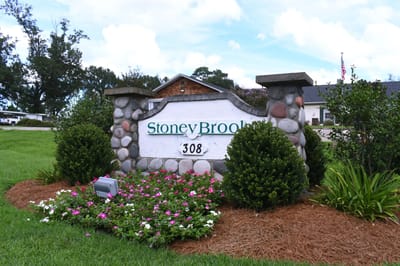 Signage for Stoneybrook Memory Care Home with flowers