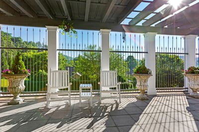 Outdoor seating area with rocking chairs and flower pots
