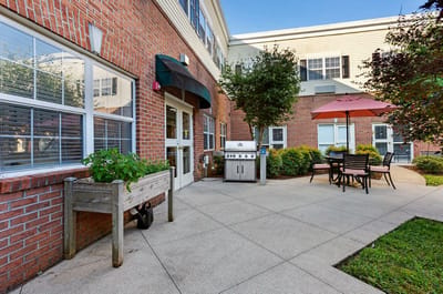 Outdoor seating area with grill and umbrellas