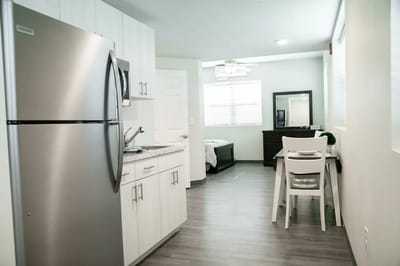 Bright and modern kitchen area in a resident room