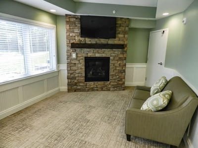 A cozy lounge area with fireplace and seating