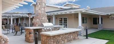Outdoor patio area with seating and grill