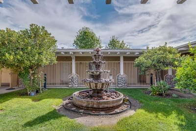 A beautiful outdoor fountain surrounded by greenery