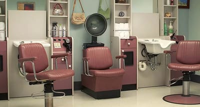 Interior view of a beauty salon with chairs and equipment