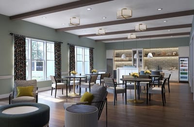 Bright and inviting common area with dining tables