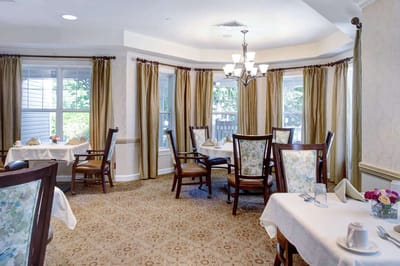 Elegant dining area with table settings and window view