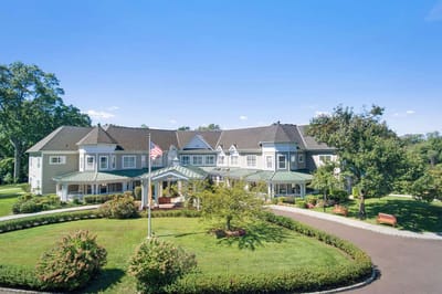 Exterior view of Sunrise at Fleetwood facility with gardens