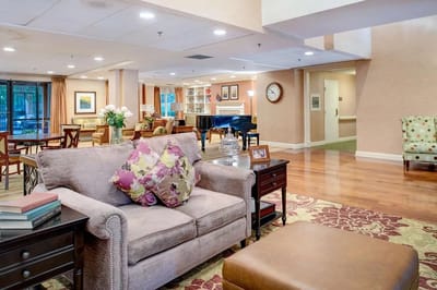 Common area with seating and piano in the background
